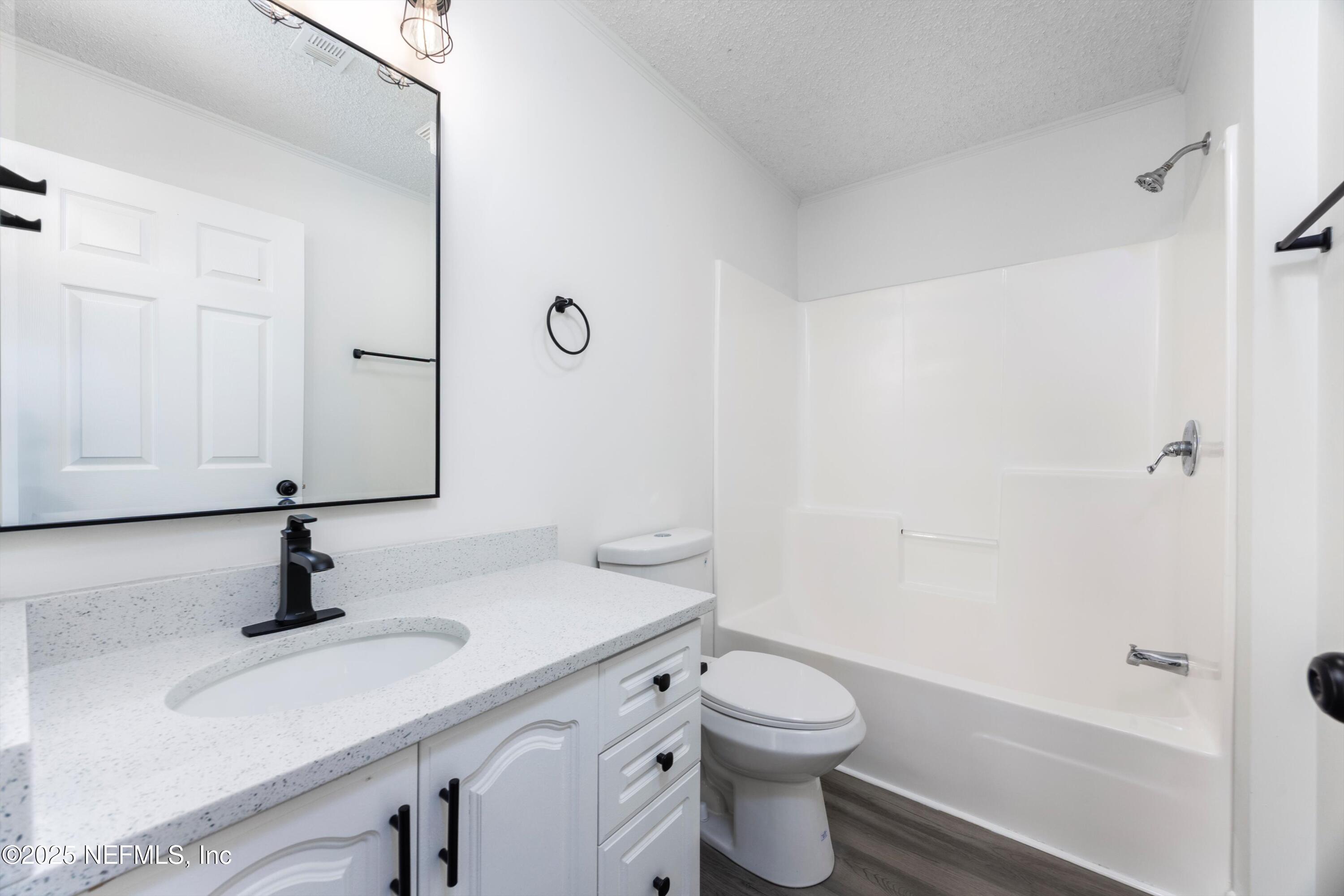 900 Helen Street St. Augustine, FL 32084 - Photo 19 of 30 a bathroom with a sink a toilet and shower