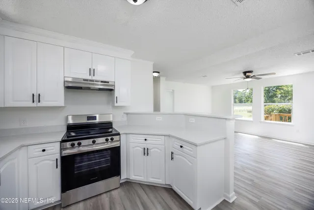 a kitchen with granite countertop a stove and a sink