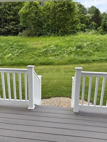 a view of a wooden deck and yard