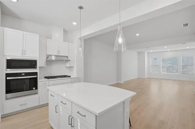 a kitchen with a stove a sink and a refrigerator