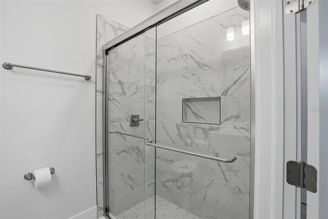 a picture of white wall with a sink and a mirror