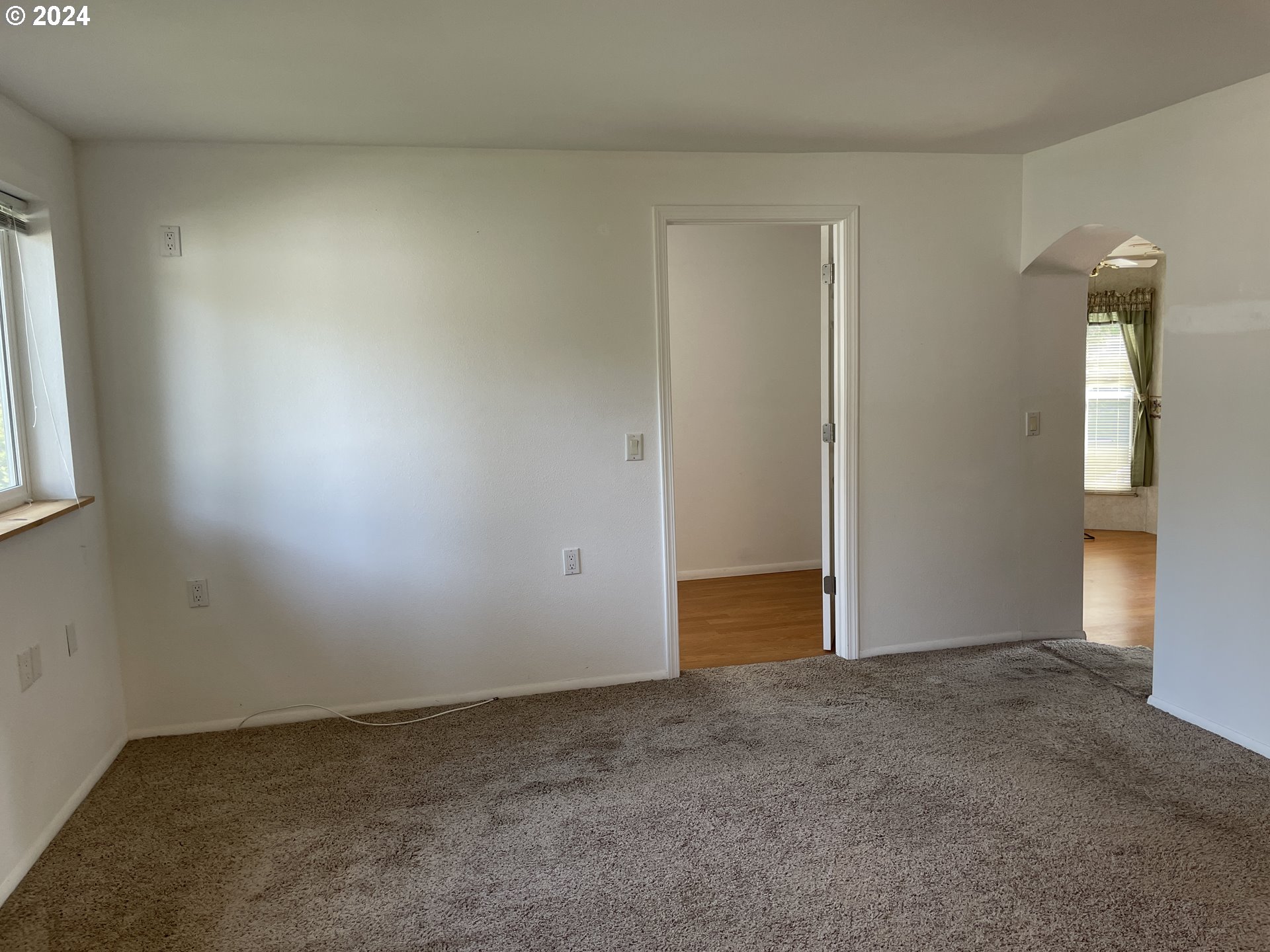 206 Bourbon Street Florence, OR 97439 - Photo 11 of 28 an empty room with windows and closet