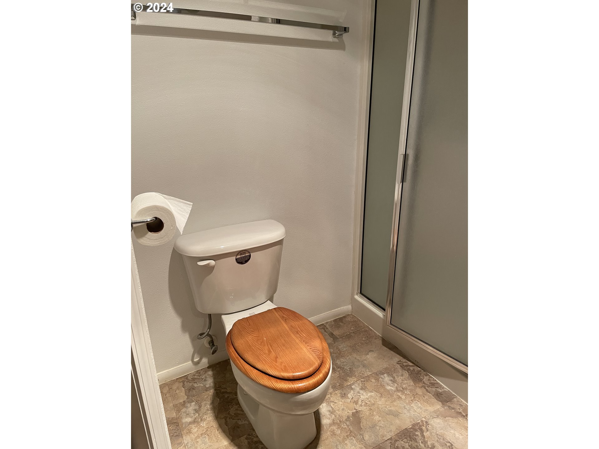 206 Bourbon Street Florence, OR 97439 - Photo 15 of 28 a white toilet sitting next to a shower