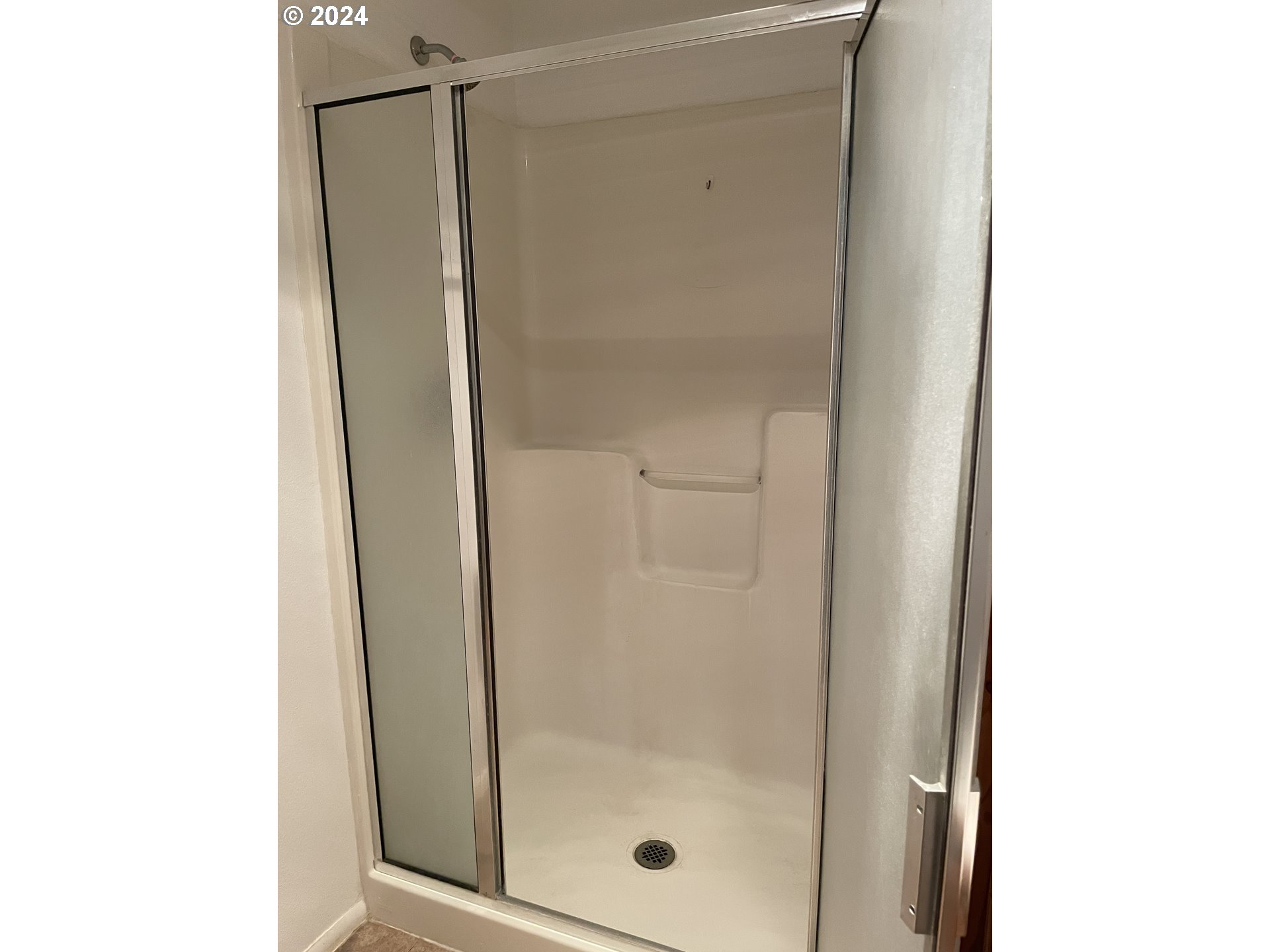 206 Bourbon Street Florence, OR 97439 - Photo 16 of 28 a bathroom with a glass shower door