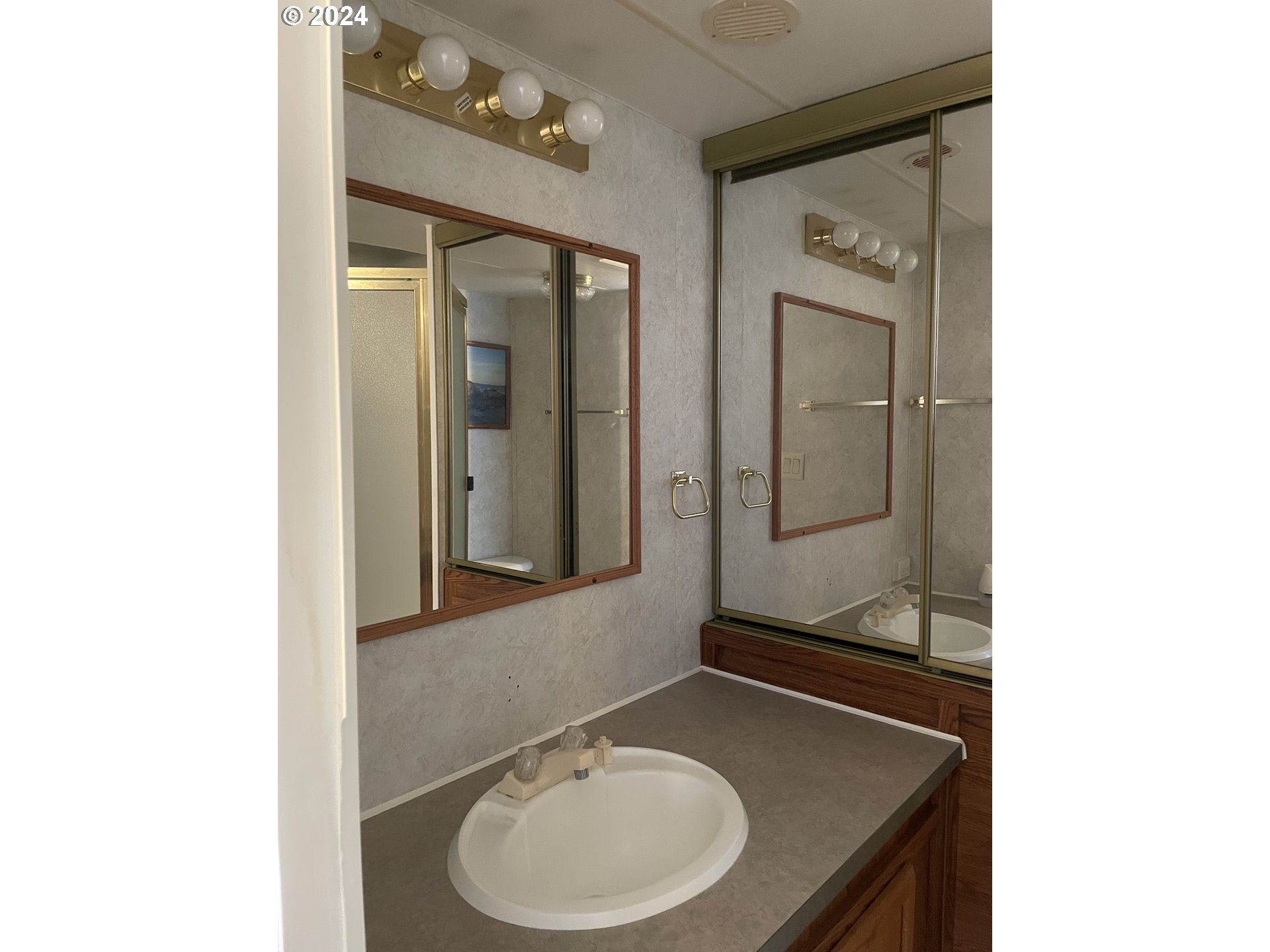 206 Bourbon Street Florence, OR 97439 - Photo 19 of 28 a bathroom with a sink and a mirror