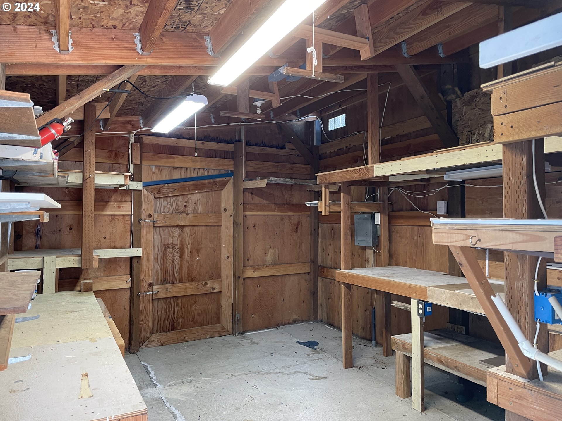 206 Bourbon Street Florence, OR 97439 - Photo 22 of 28 a utility room with dryer and racks