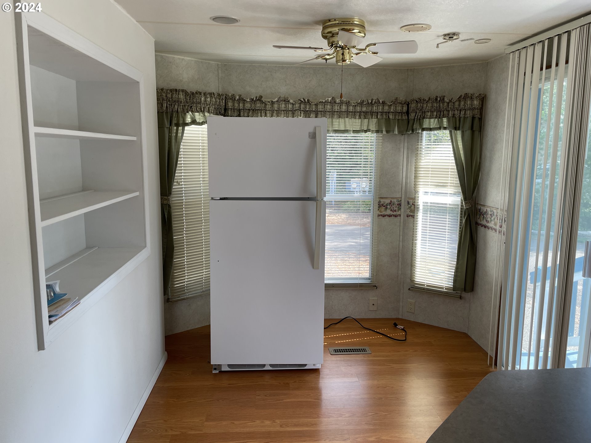 206 Bourbon Street Florence, OR 97439 - Photo 24 of 28 a view of walk in closet with window and wooden floor