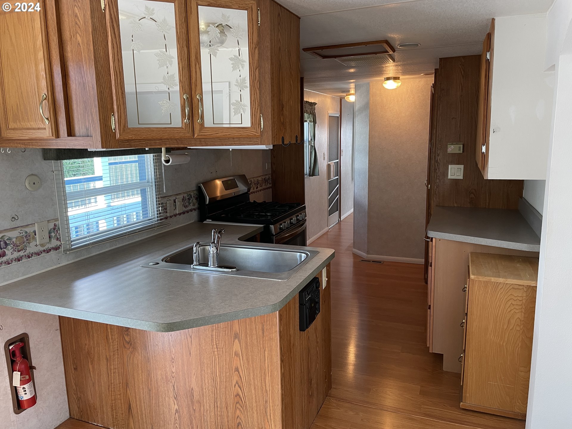 206 Bourbon Street Florence, OR 97439 - Photo 26 of 28 a kitchen with stainless steel appliances granite countertop a sink a refrigerator and a granite counter tops