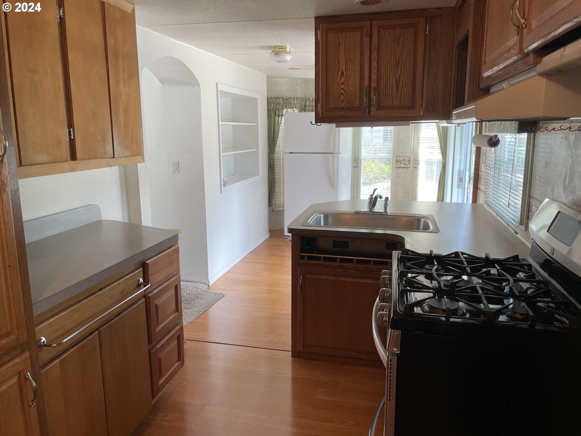 206 Bourbon Street Florence, OR 97439 - Photo 27 of 28 a kitchen with a stove and a refrigerator