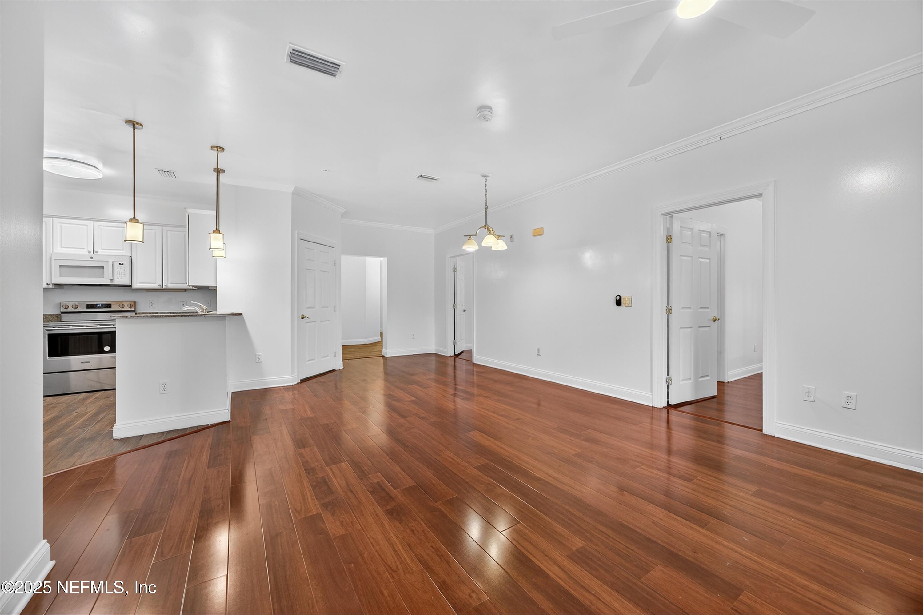 210 Presidents Cup Way, Unit 101 St. Augustine, FL 32092 - Photo 11 of 37 a view of kitchen with wooden floor and window
