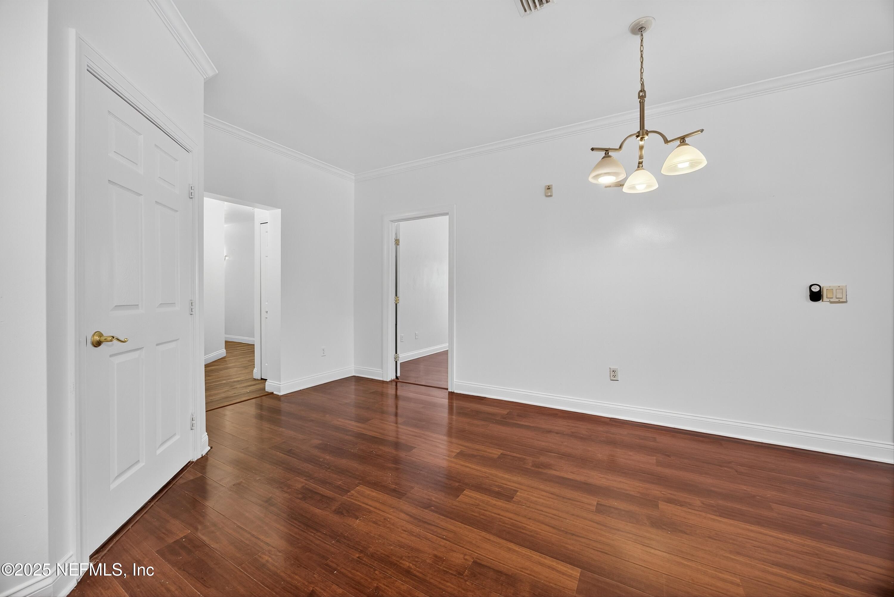 210 Presidents Cup Way, Unit 101 St. Augustine, FL 32092 - Photo 12 of 37 a view of an empty room with wooden floor