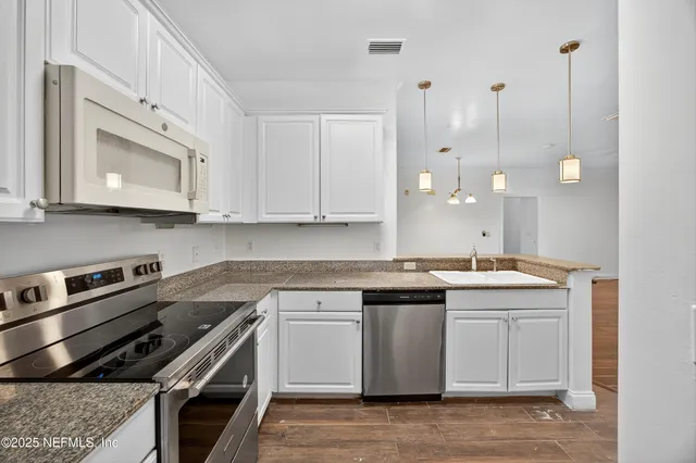 a kitchen with a sink stove and cabinets