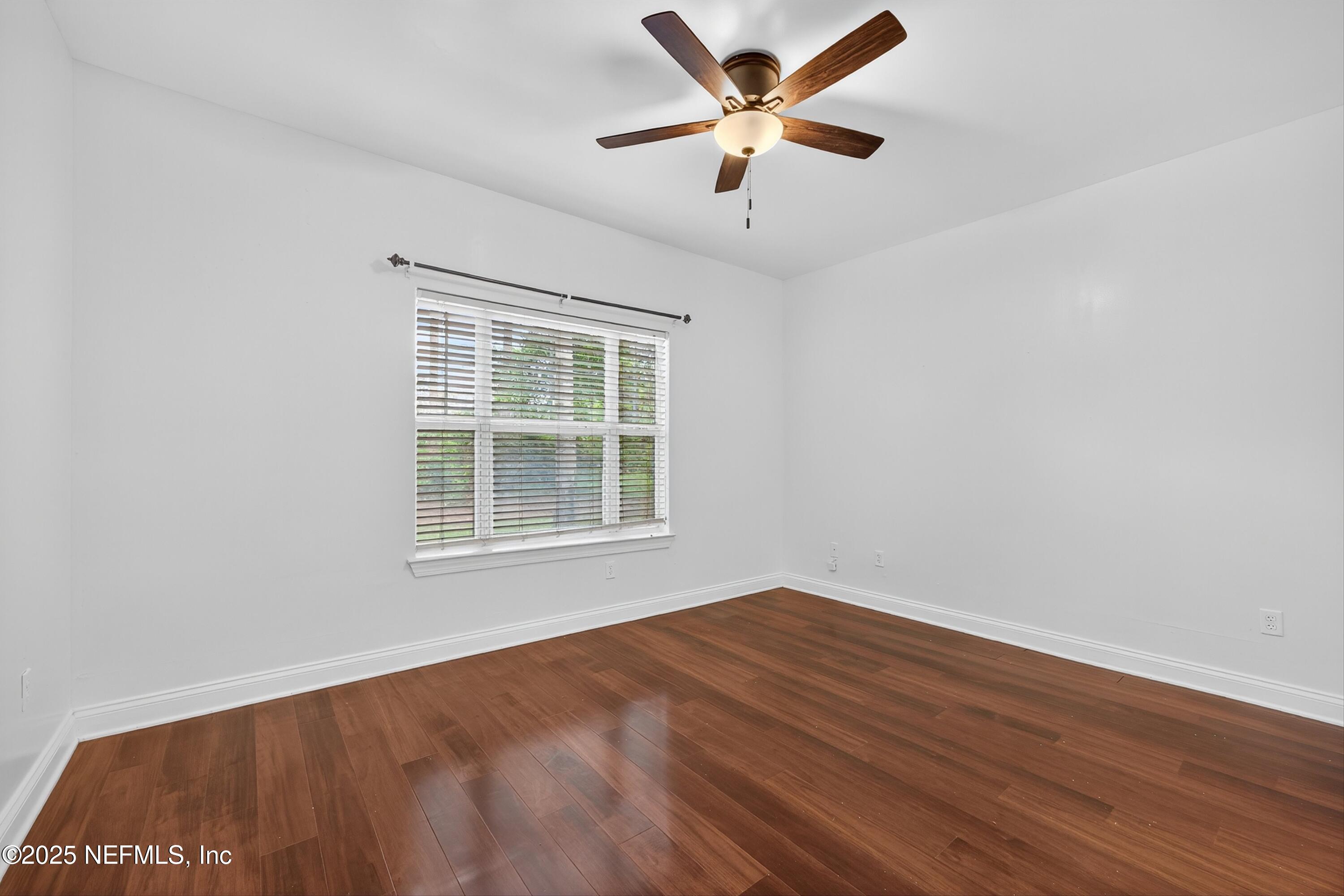 210 Presidents Cup Way, Unit 101 St. Augustine, FL 32092 - Photo 20 of 37 an empty room with wooden floor and windows