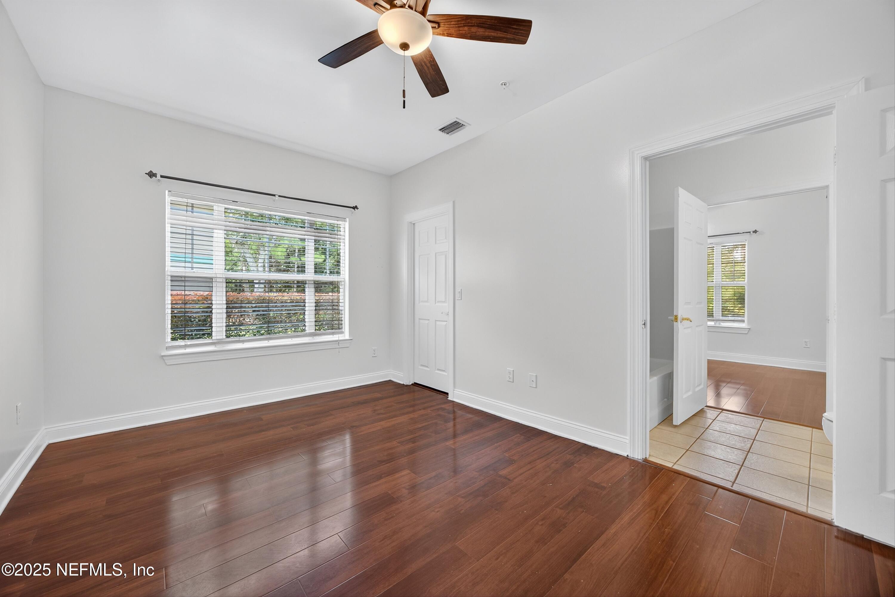 210 Presidents Cup Way, Unit 101 St. Augustine, FL 32092 - Photo 25 of 37 a view of an empty room with wooden floor and a window