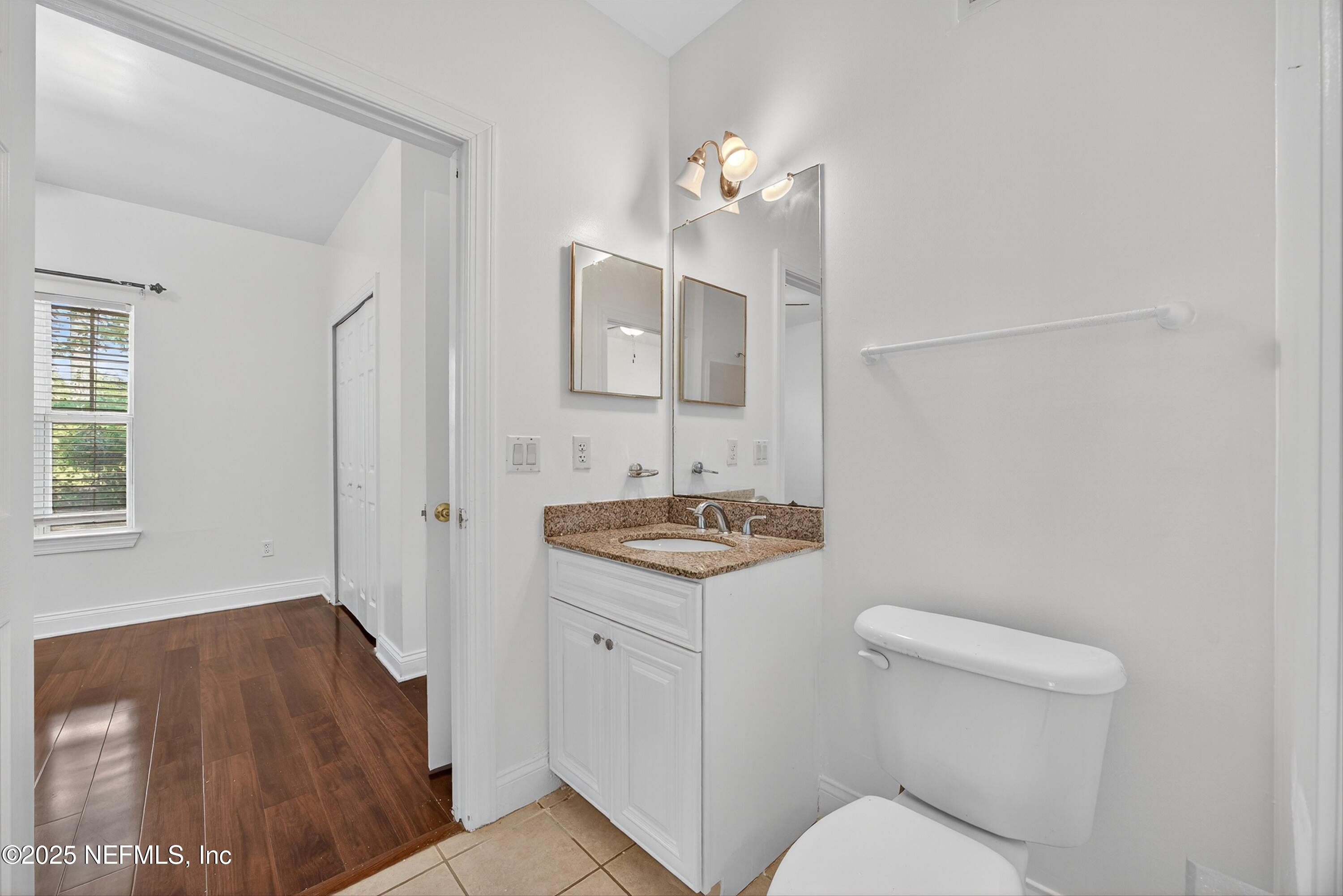 210 Presidents Cup Way, Unit 101 St. Augustine, FL 32092 - Photo 27 of 37 a bathroom with a sink toilet and mirror