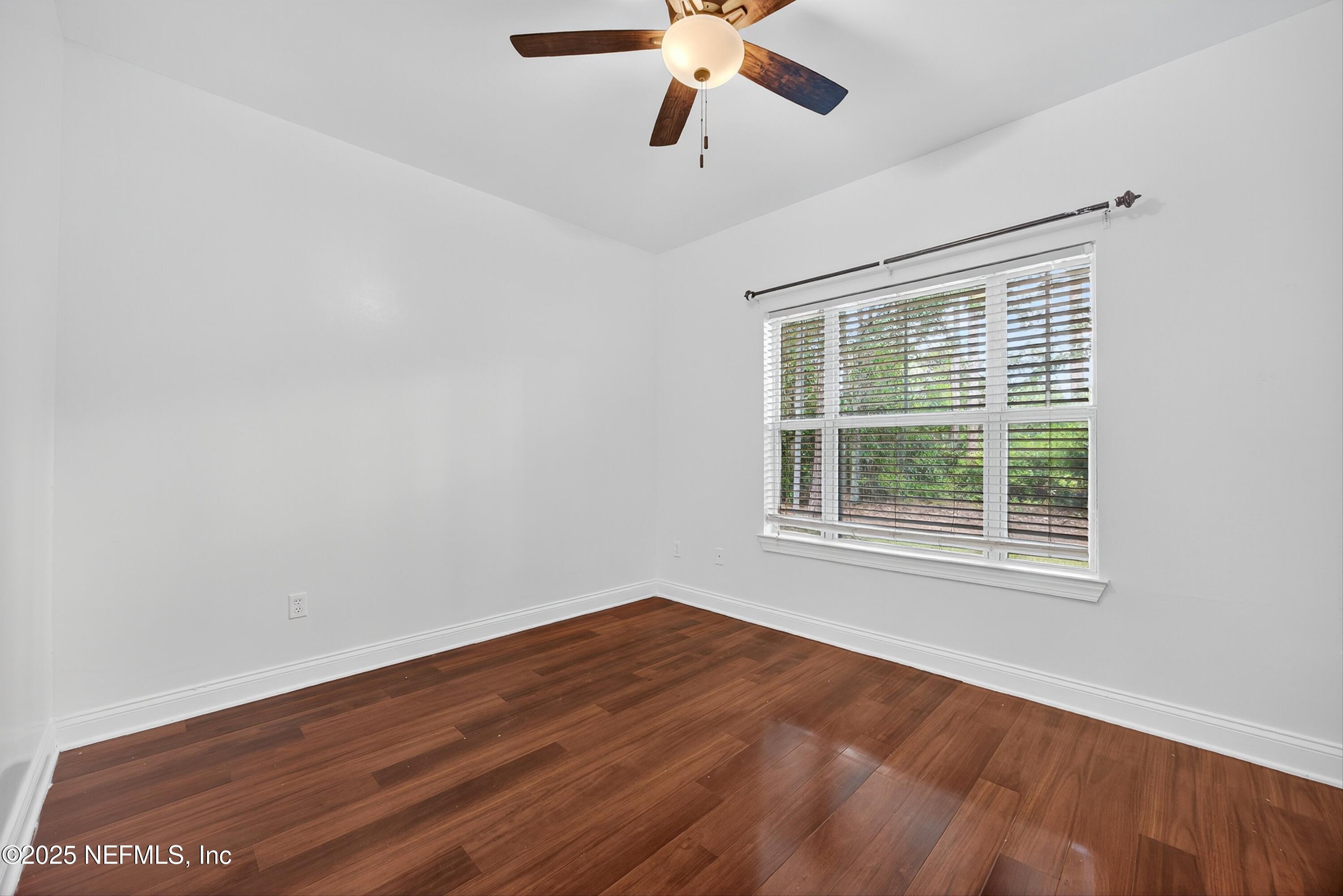 210 Presidents Cup Way, Unit 101 St. Augustine, FL 32092 - Photo 30 of 37 a view of an empty room with wooden floor and a window