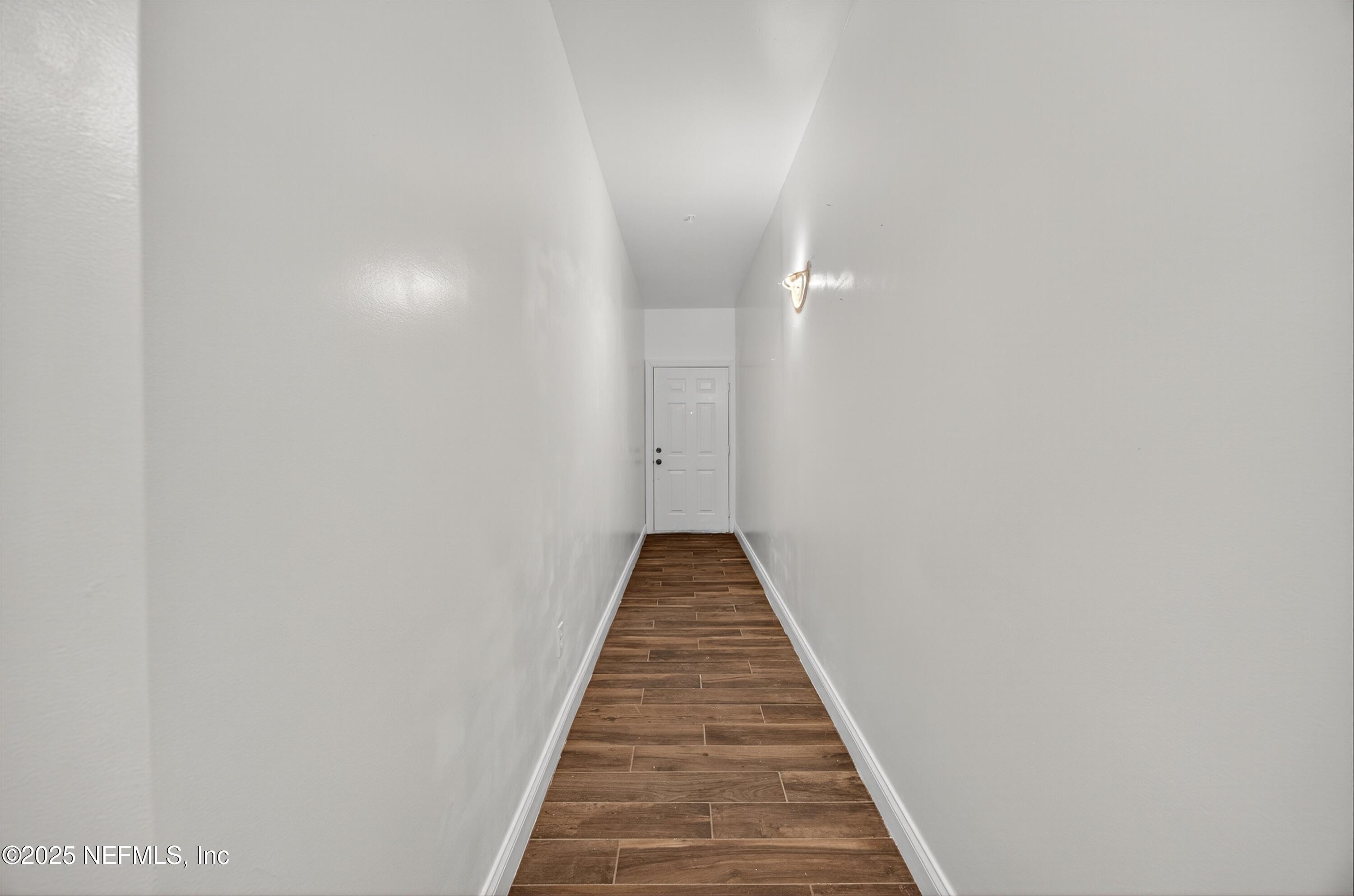 210 Presidents Cup Way, Unit 101 St. Augustine, FL 32092 - Photo 5 of 37 a view of a hallway with wooden floor