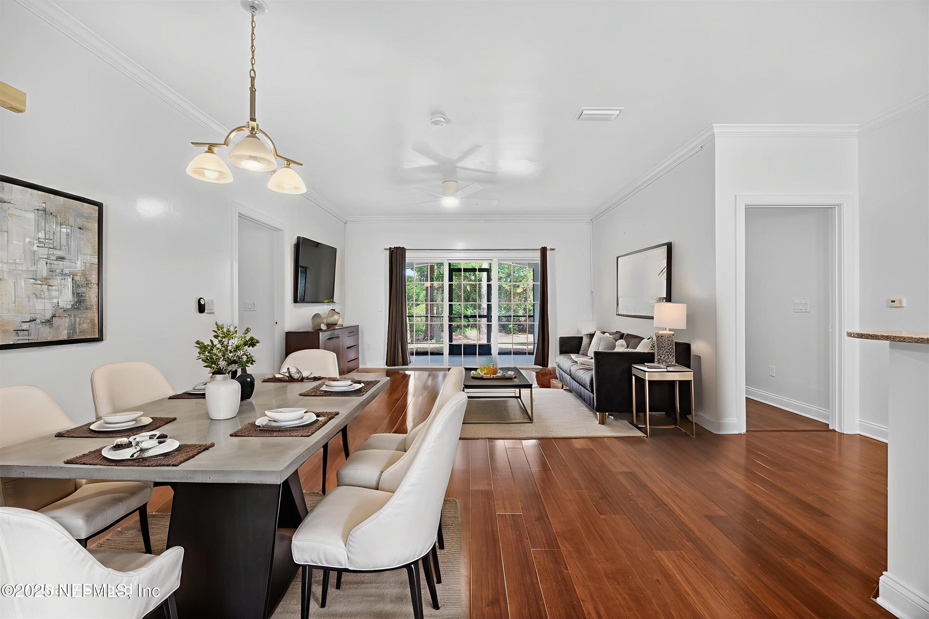 210 Presidents Cup Way, Unit 101 St. Augustine, FL 32092 - Photo 6 of 37 a view of a dining room with furniture window and wooden floor