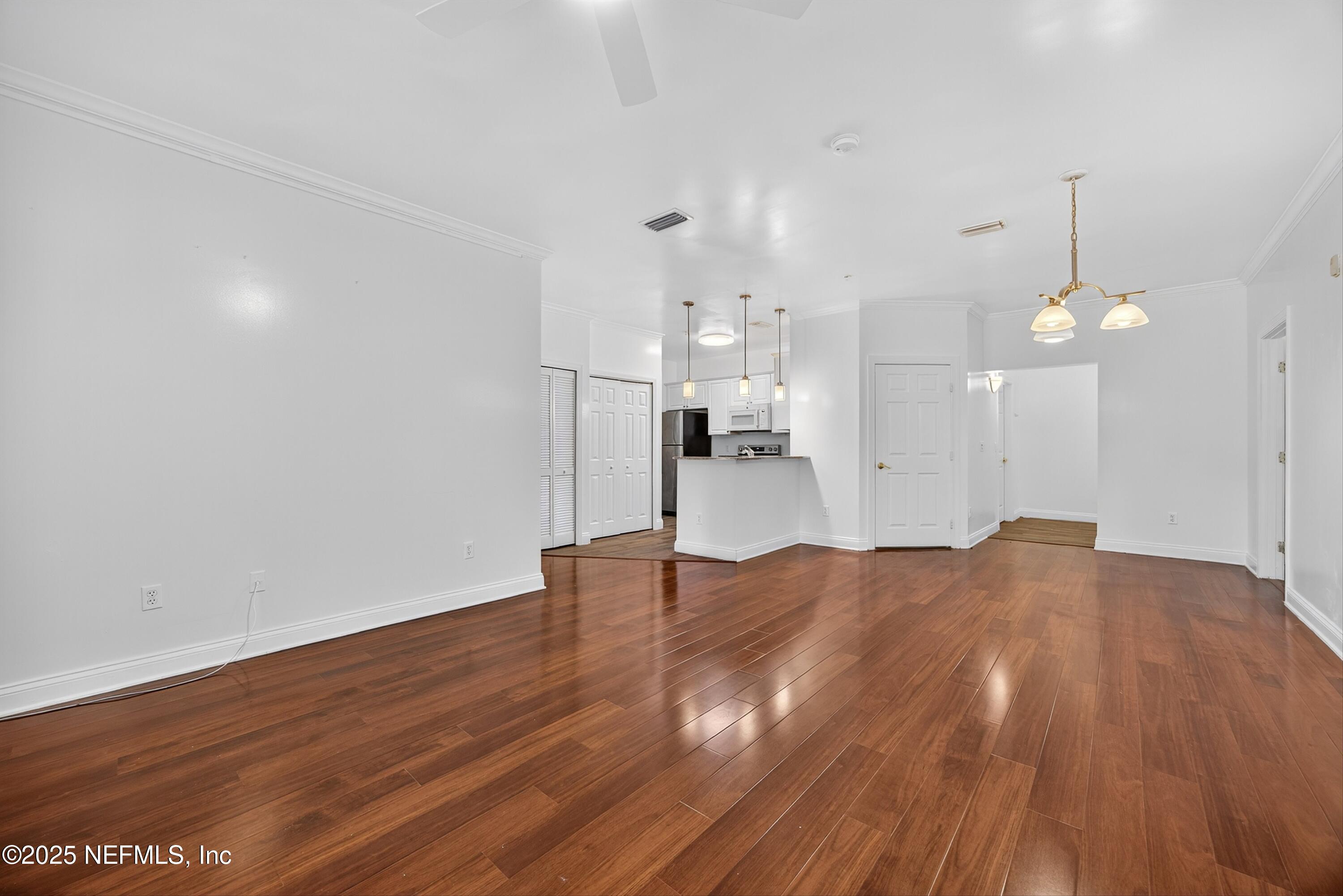 210 Presidents Cup Way, Unit 101 St. Augustine, FL 32092 - Photo 9 of 37 a view of empty room with wooden floor