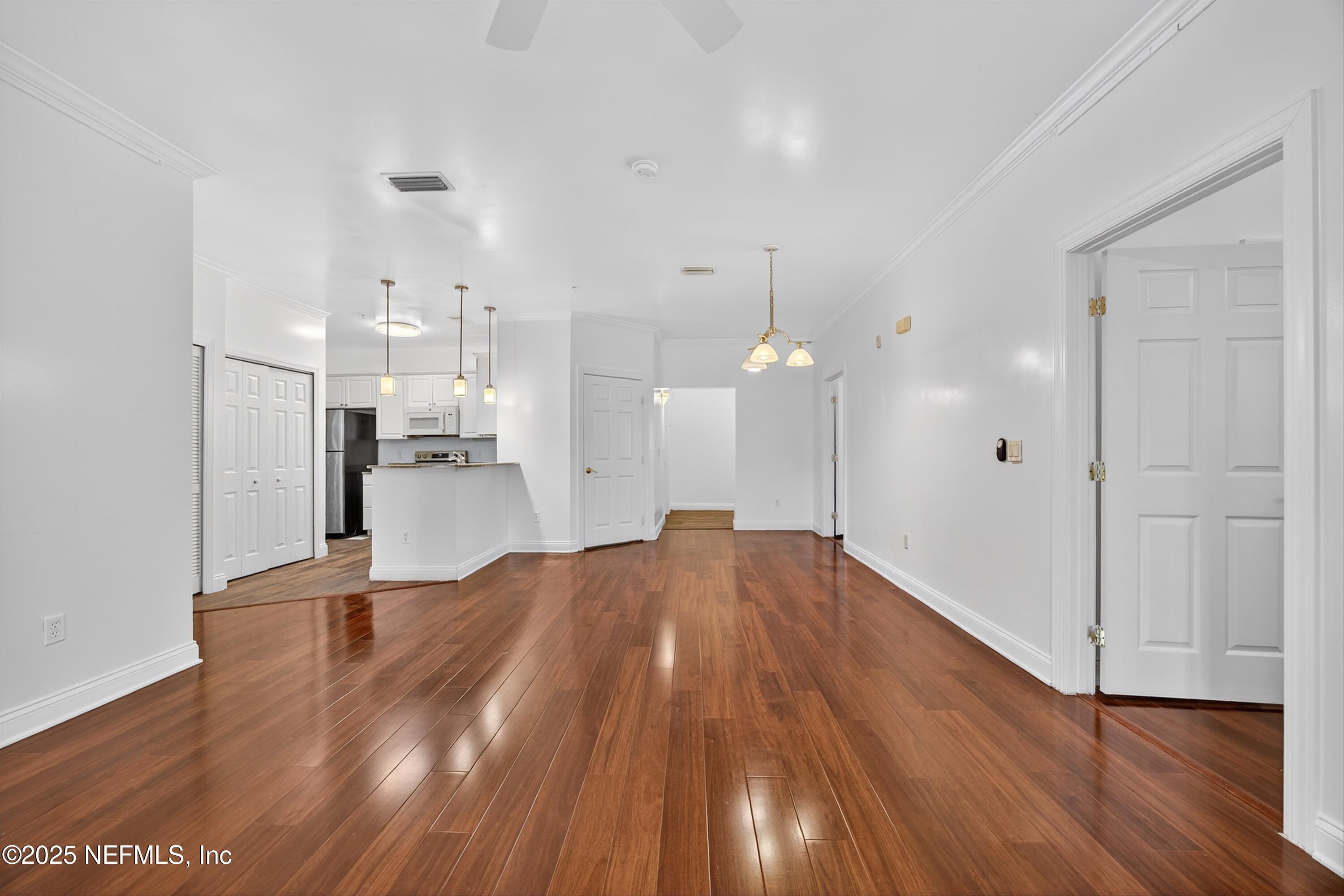 210 Presidents Cup Way, Unit 101 St. Augustine, FL 32092 - Photo 10 of 37 a view of empty room with wooden floor