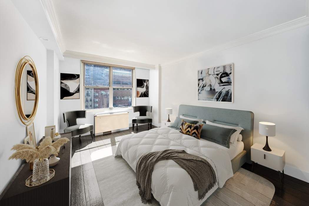 207 East 74th Street, Unit 7F Manhattan, NY 10021 - Photo 8 of 10 a bedroom with bed and a couch