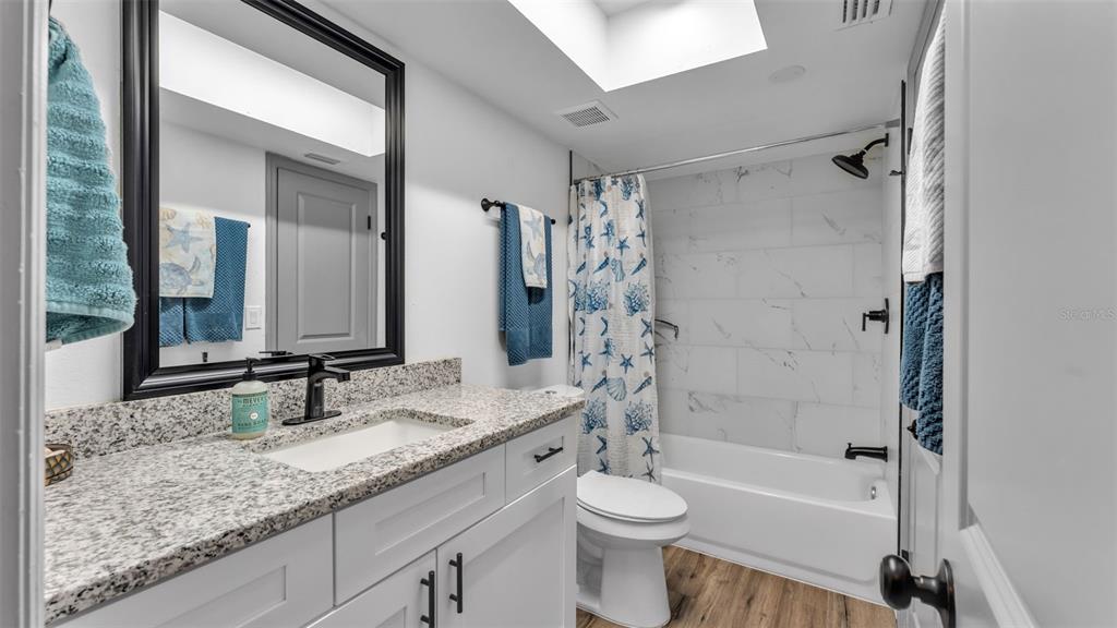 1005 Swilley Road Plant City, FL 33567 - Photo 13 of 24 a bathroom with a granite countertop sink toilet and shower