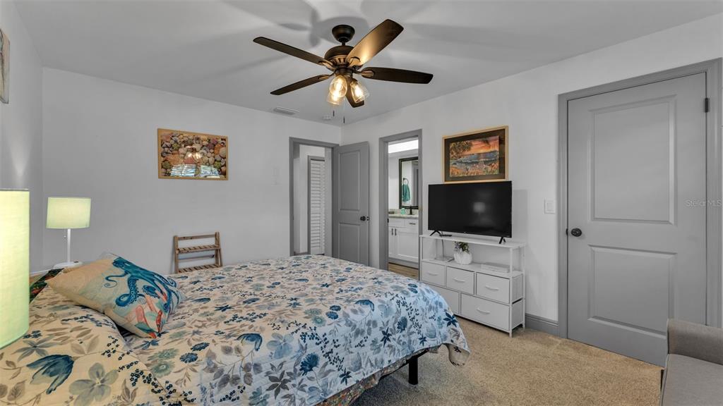 1005 Swilley Road Plant City, FL 33567 - Photo 14 of 24 a bedroom with a bed and a flat screen tv