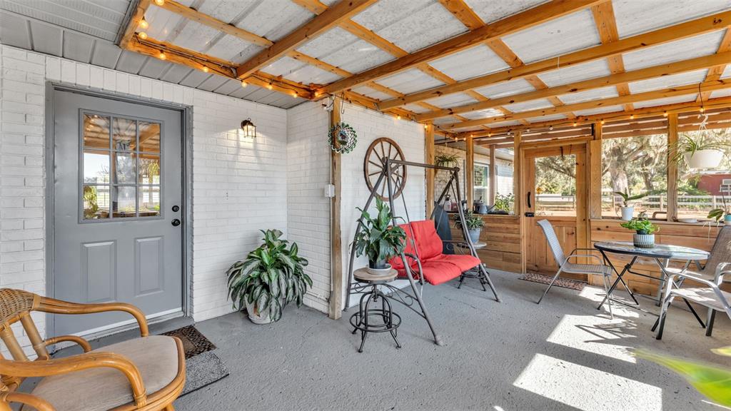 1005 Swilley Road Plant City, FL 33567 - Photo 19 of 24 a dining room with furniture and floor to ceiling window