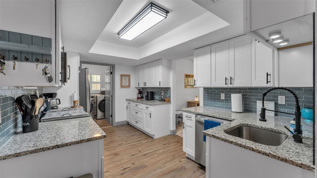1005 Swilley Road Plant City, FL 33567 - Photo 3 of 24 a kitchen with sink a refrigerator and cabinets