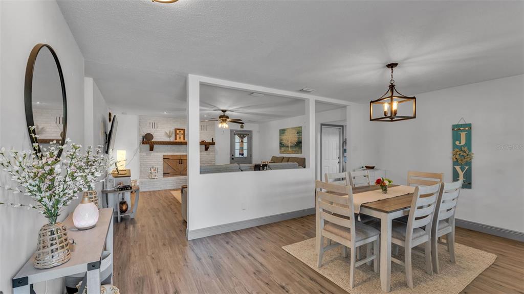 1005 Swilley Road Plant City, FL 33567 - Photo 4 of 24 a view of a dining room with furniture and wooden floor