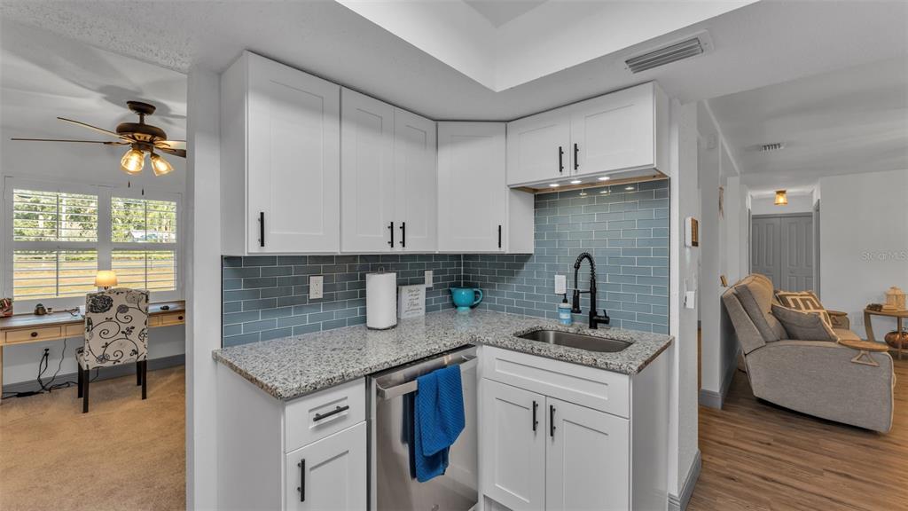 1005 Swilley Road Plant City, FL 33567 - Photo 9 of 24 a kitchen with stainless steel appliances granite countertop a sink refrigerator and cabinets