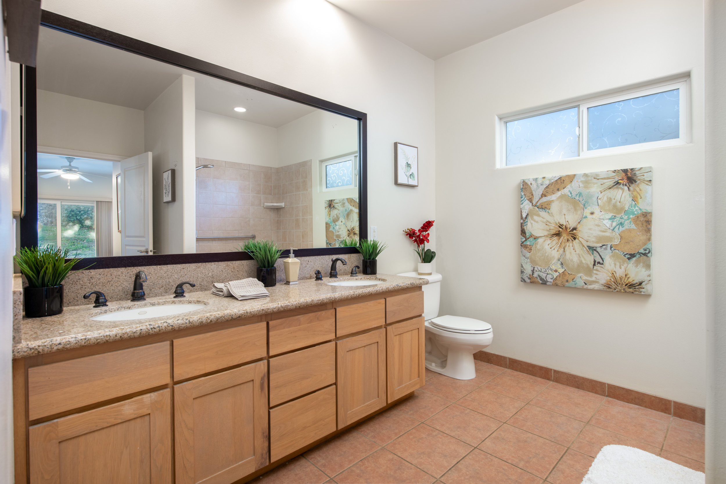 68-1693 Malie Street Waikoloa, HI 96738 - Photo 12 of 25 a bathroom with a double vanity sink mirror and toilet