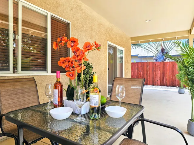 a view of a dining room with furniture and potted plants