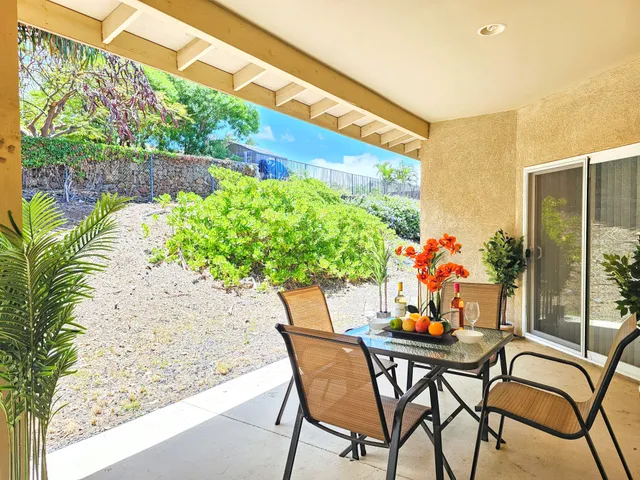 a backyard of a house with outdoor seating