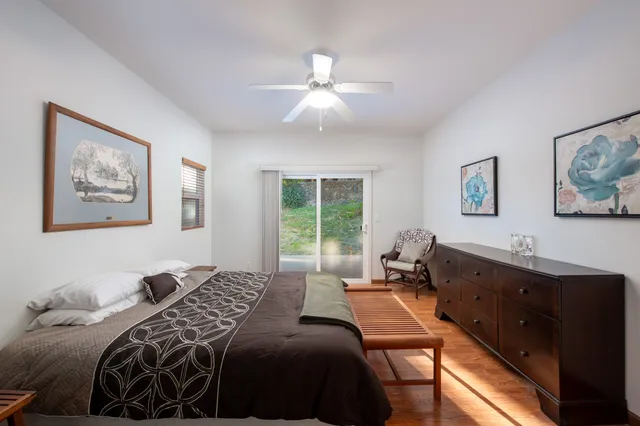 a room with a bed and painting on the wall