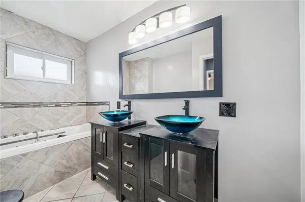 a bathroom with double sink and a mirror