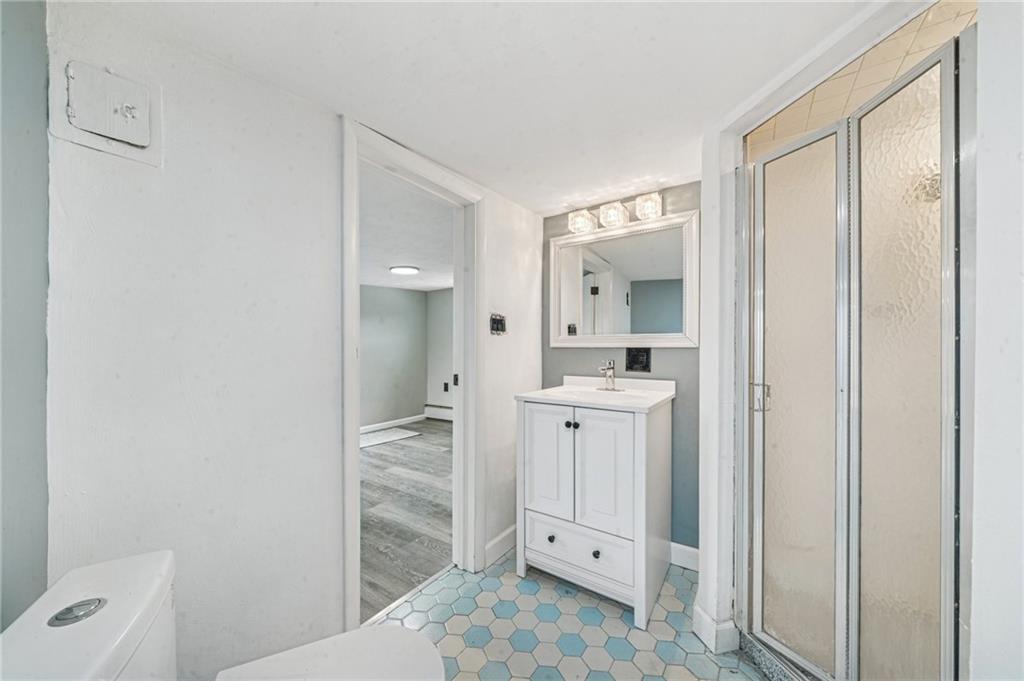 848 Pittsburgh Street Springdale, PA 15144 - Photo 14 of 25 a bathroom with a shower sink and mirror