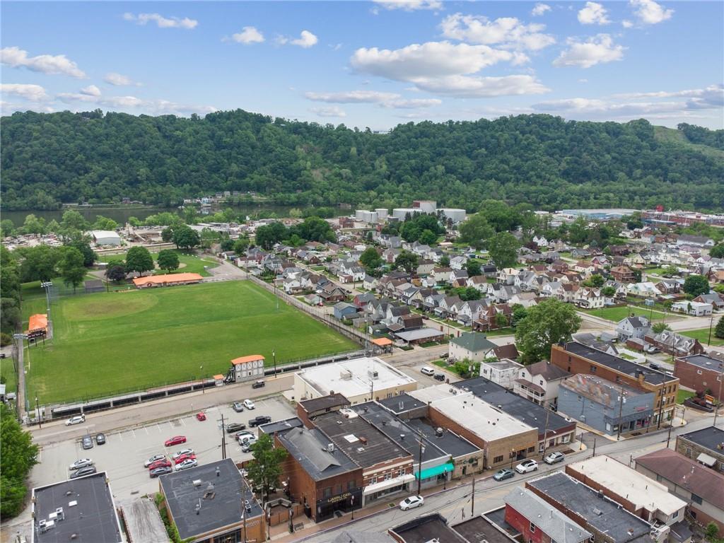 848 Pittsburgh Street Springdale, PA 15144 - Photo 2 of 25 an aerial view of a city with lots of residential buildings and mountain view in back
