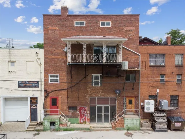 a front view of a building with parking