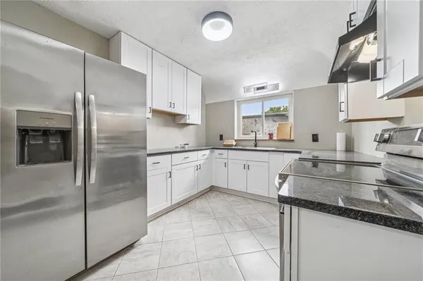 a kitchen with a sink stainless steel appliances and cabinets