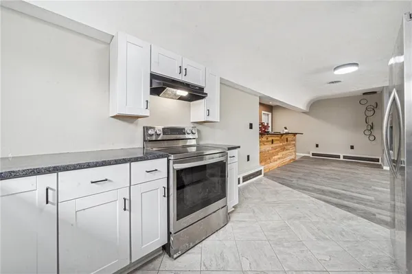 a kitchen with white cabinets and white appliances