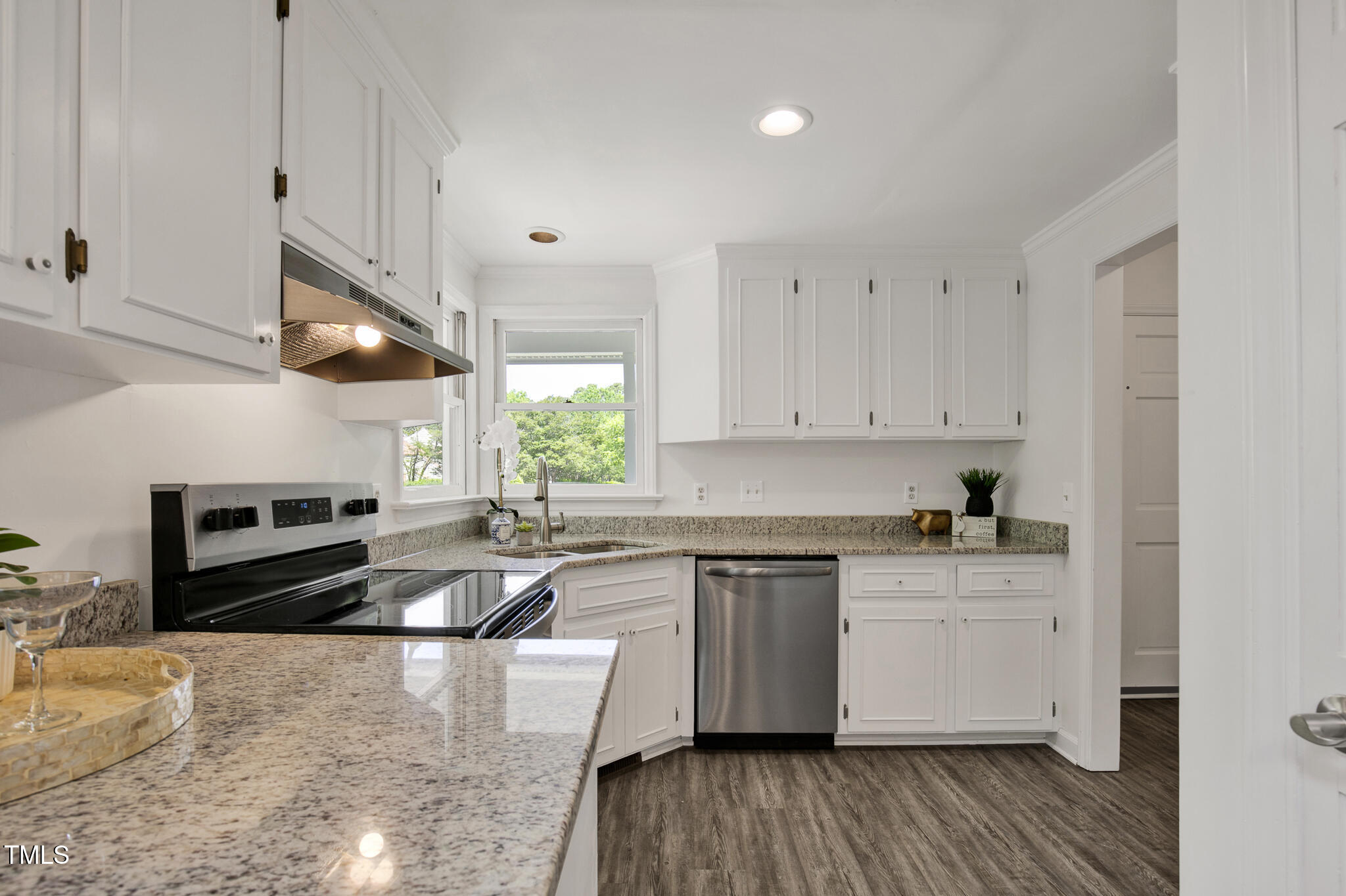 2611 Sawmill Road Raleigh, NC 27613 - Photo 11 of 31 a kitchen with granite countertop a sink a counter space appliances and cabinets