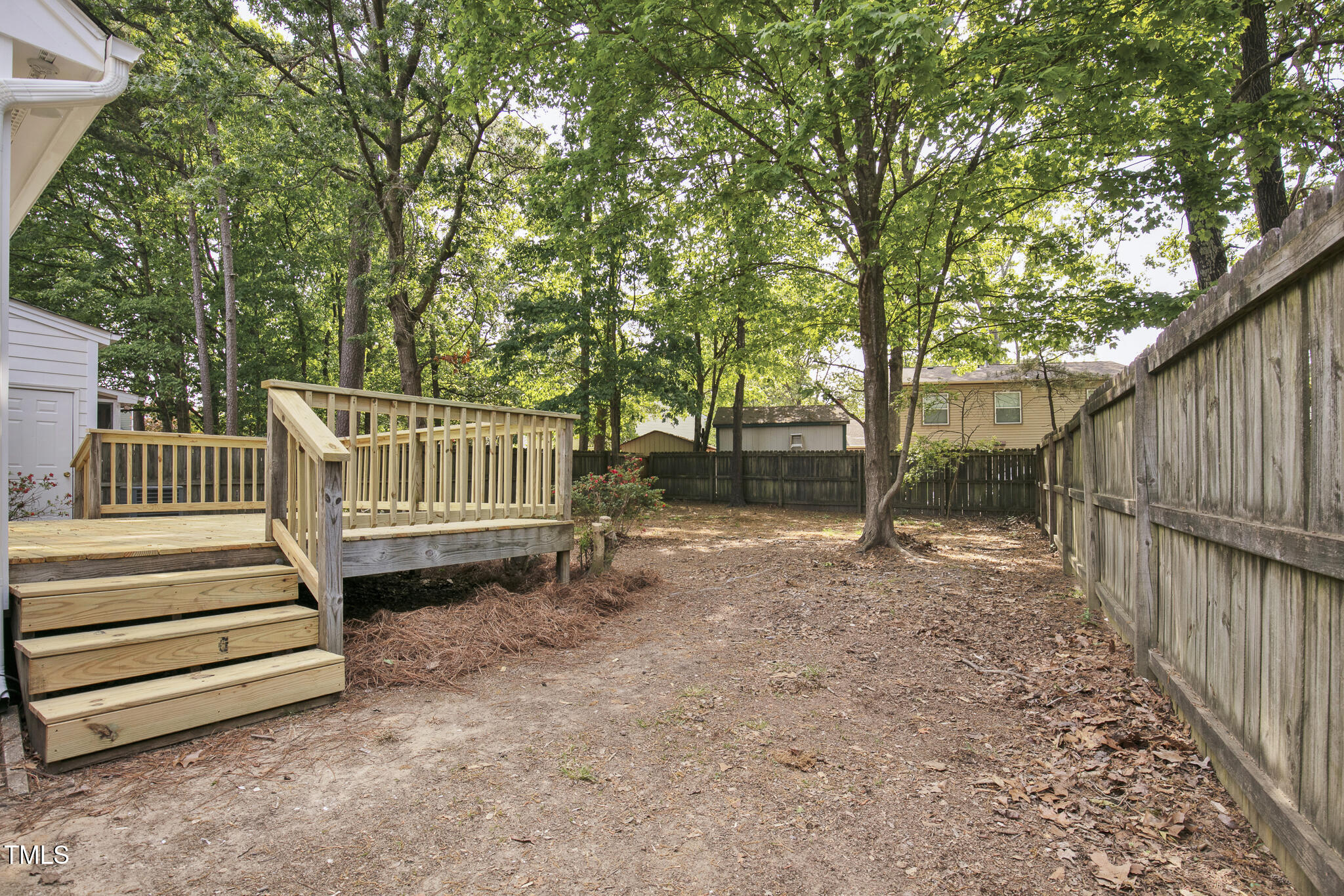 2611 Sawmill Road Raleigh, NC 27613 - Photo 26 of 31 a view of backyard with deck and a garden
