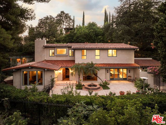 a view of a house with pool and chairs