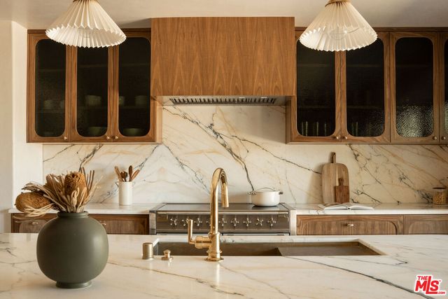 a kitchen with a sink a counter and cabinets