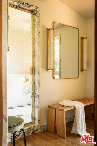 a bedroom with a bed a couch and dresser