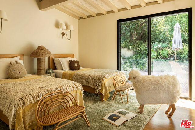 a bedroom with a bed and a painting on the wall