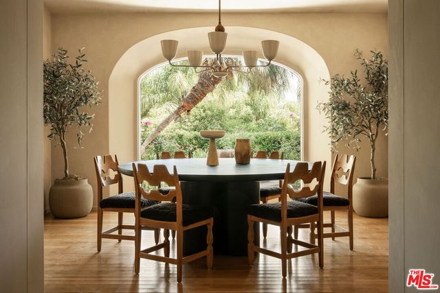 a dining room with furniture window and wooden floor