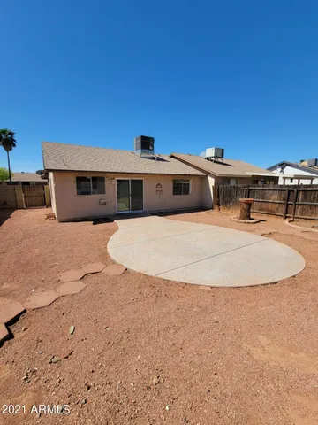 a view of a white house with a yard