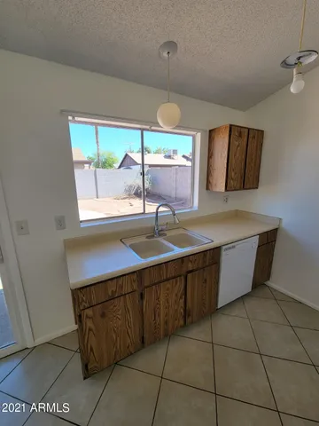 a kitchen with a sink a counter top space and cabinets